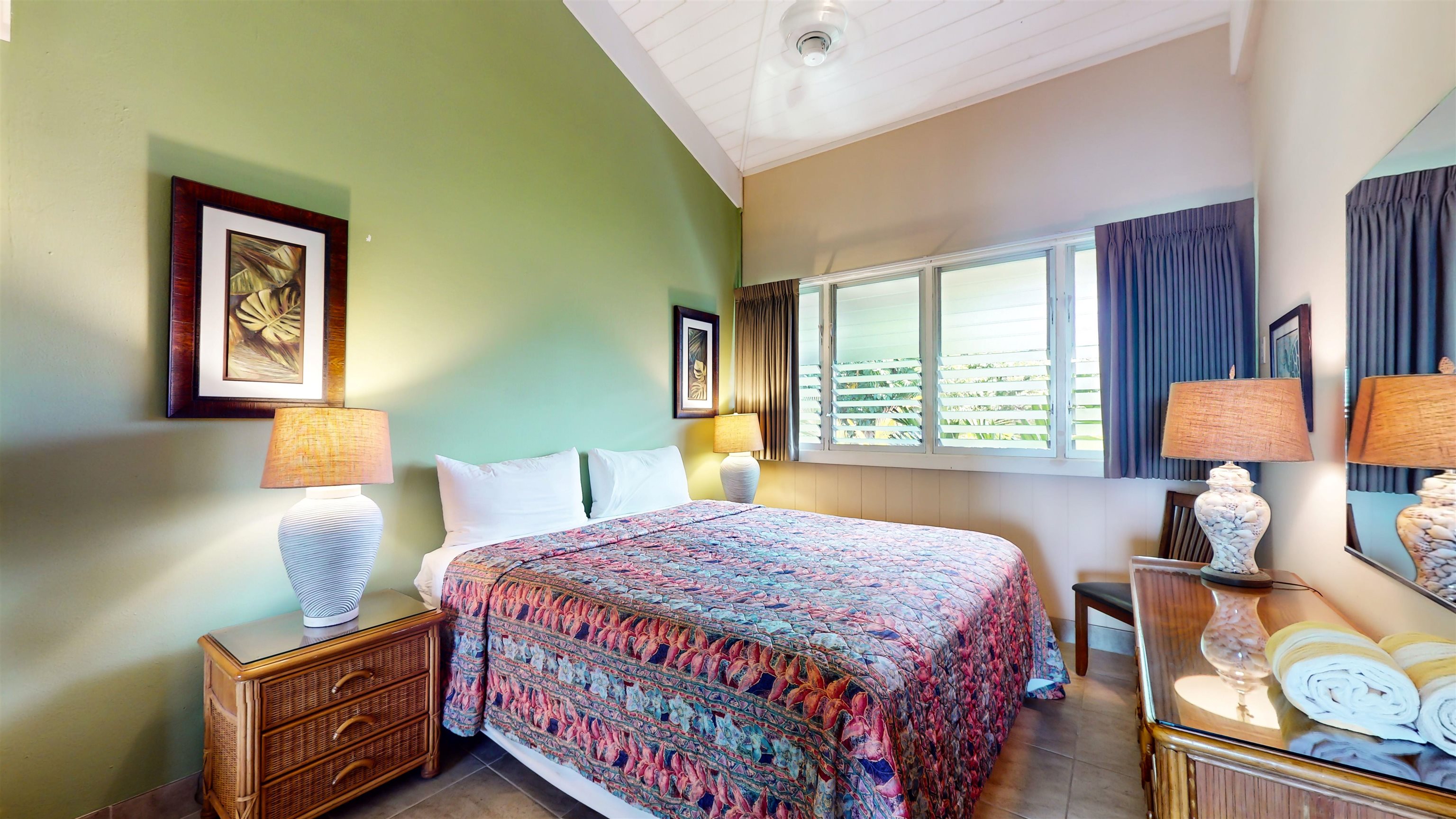 5255 Lower Honoapiilani Road, Unit 219 Lahaina, HI 96761 - Photo 5 of 12 a bedroom with a bed and lamp