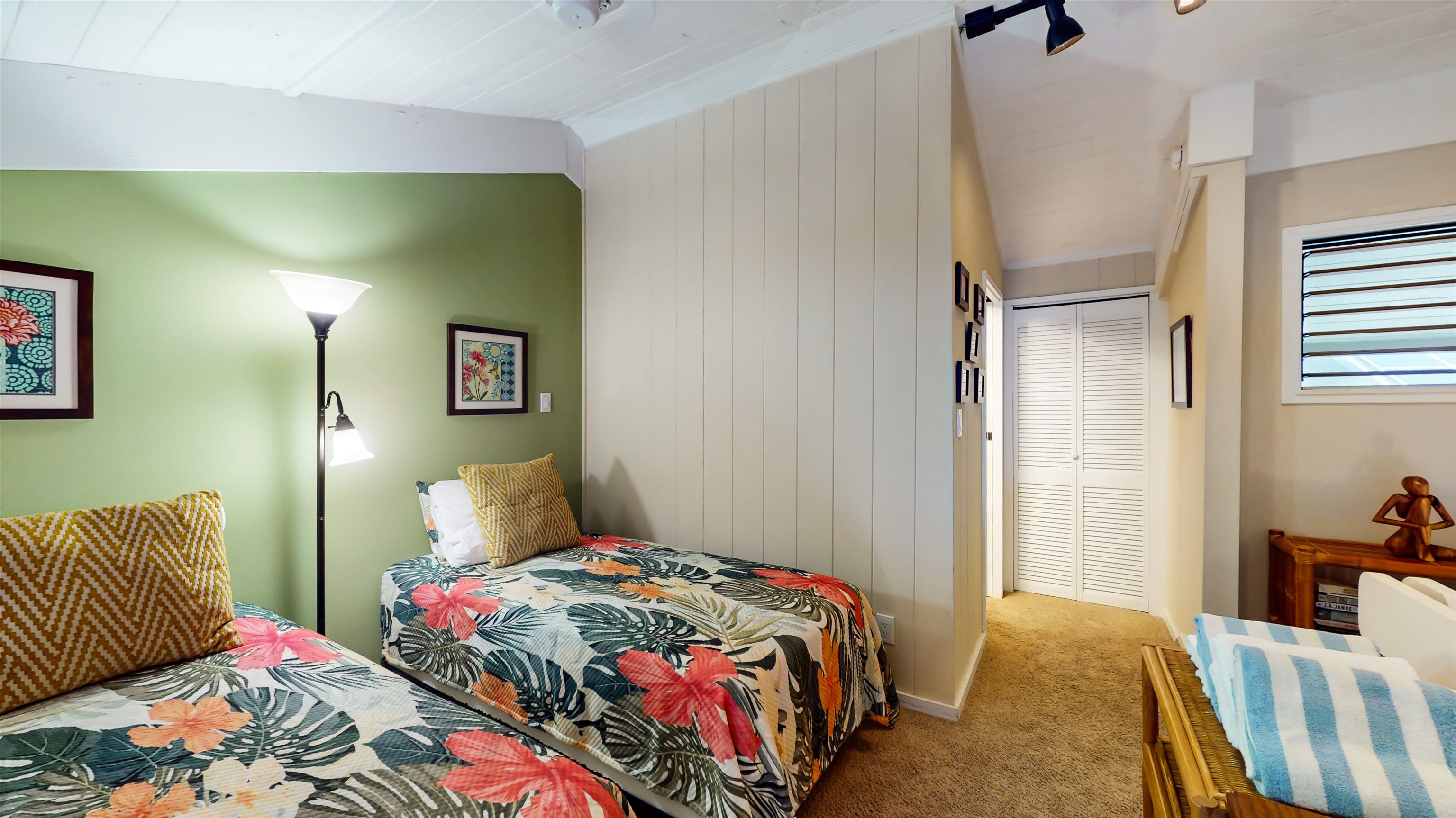 5255 Lower Honoapiilani Road, Unit 219 Lahaina, HI 96761 - Photo 8 of 12 a bedroom with a bed and wooden floor