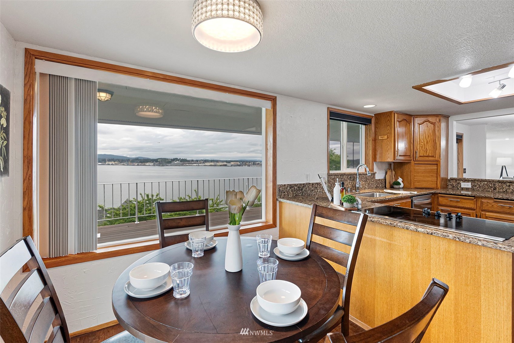 3891 Rama Drive East Port Orchard, WA 98366 - Photo 13 of 32 a dining room with furniture a large window and kitchen view