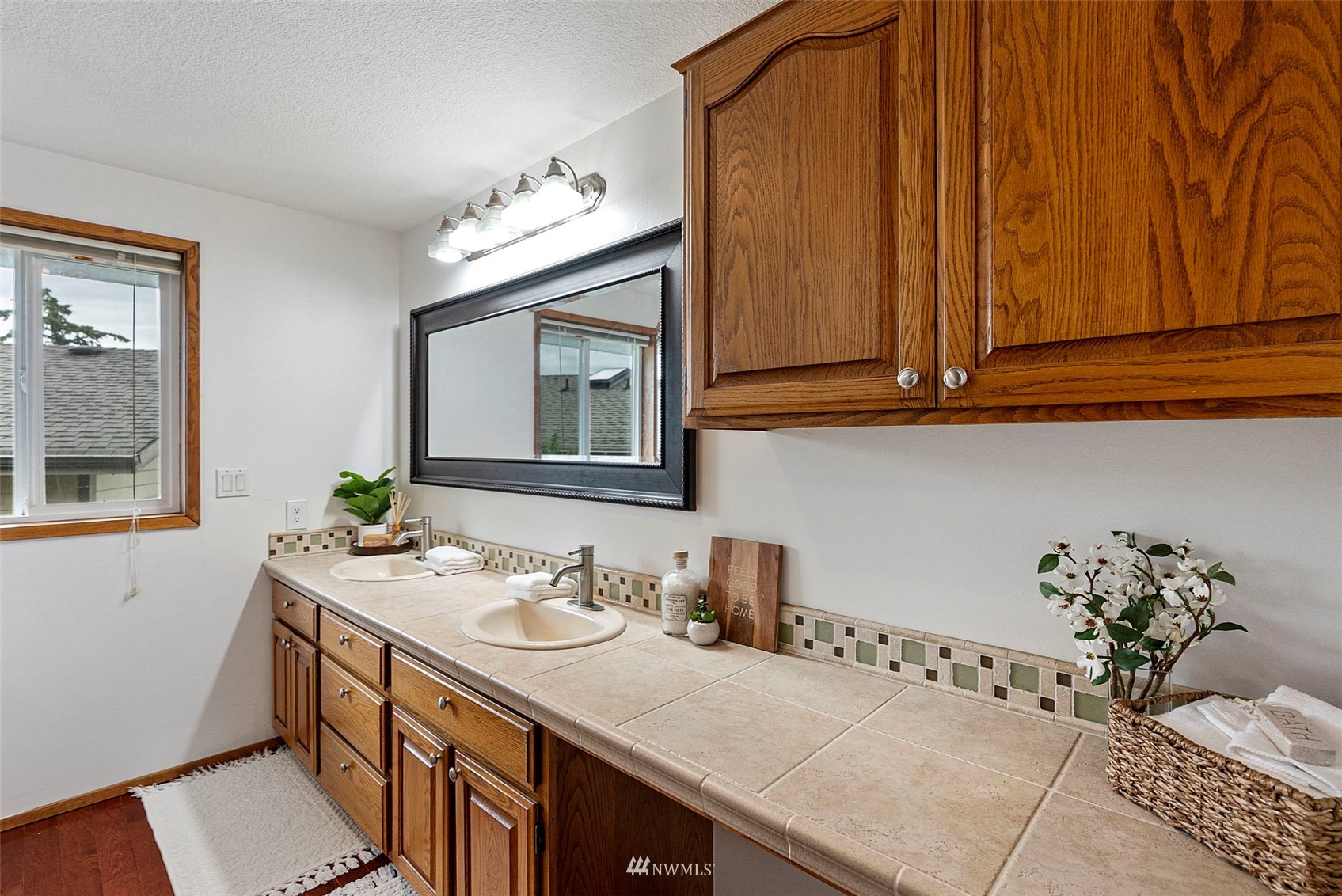 3891 Rama Drive East Port Orchard, WA 98366 - Photo 17 of 32 a bathroom with a sink and a mirror
