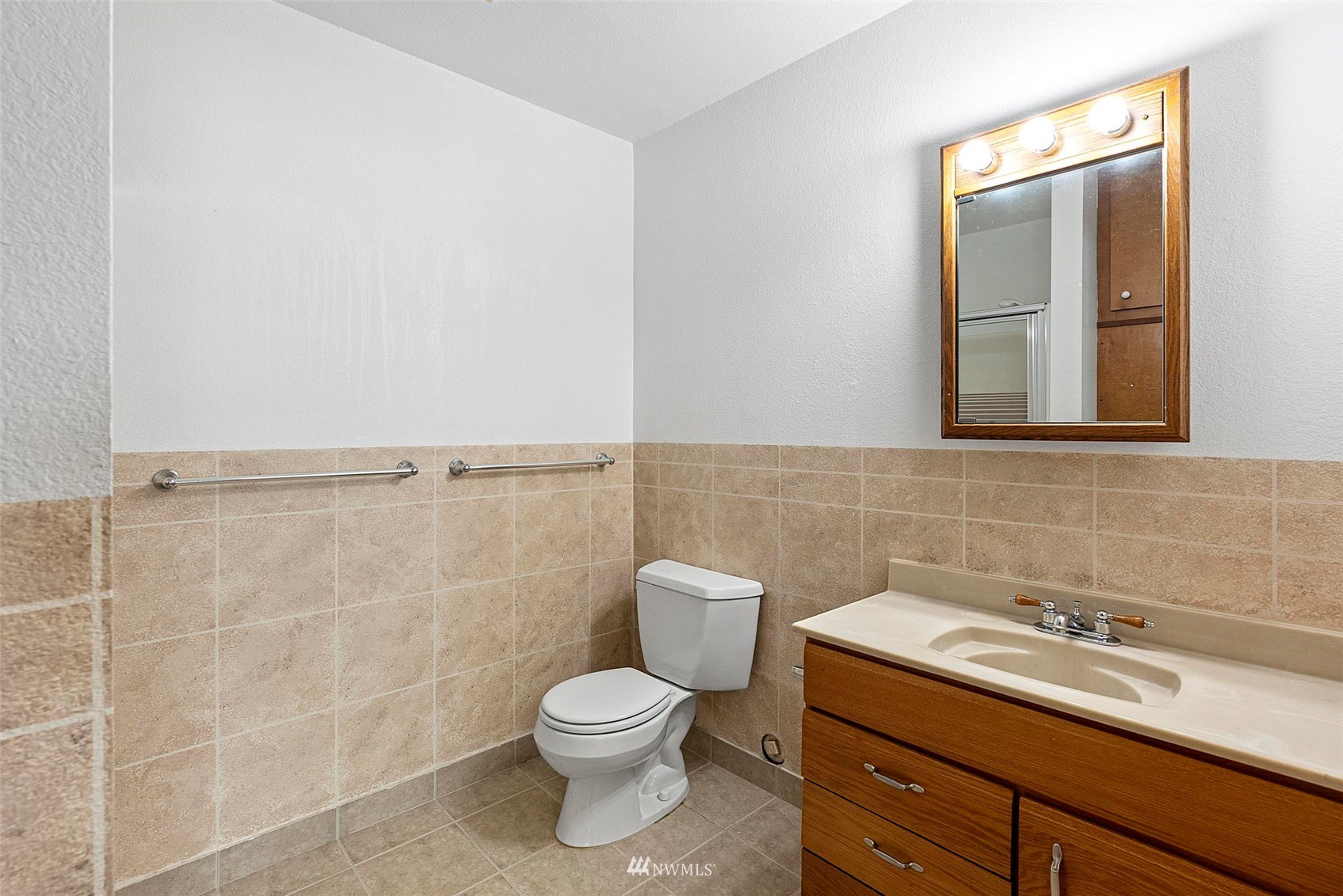 3891 Rama Drive East Port Orchard, WA 98366 - Photo 26 of 32 a bathroom with a toilet sink and mirror