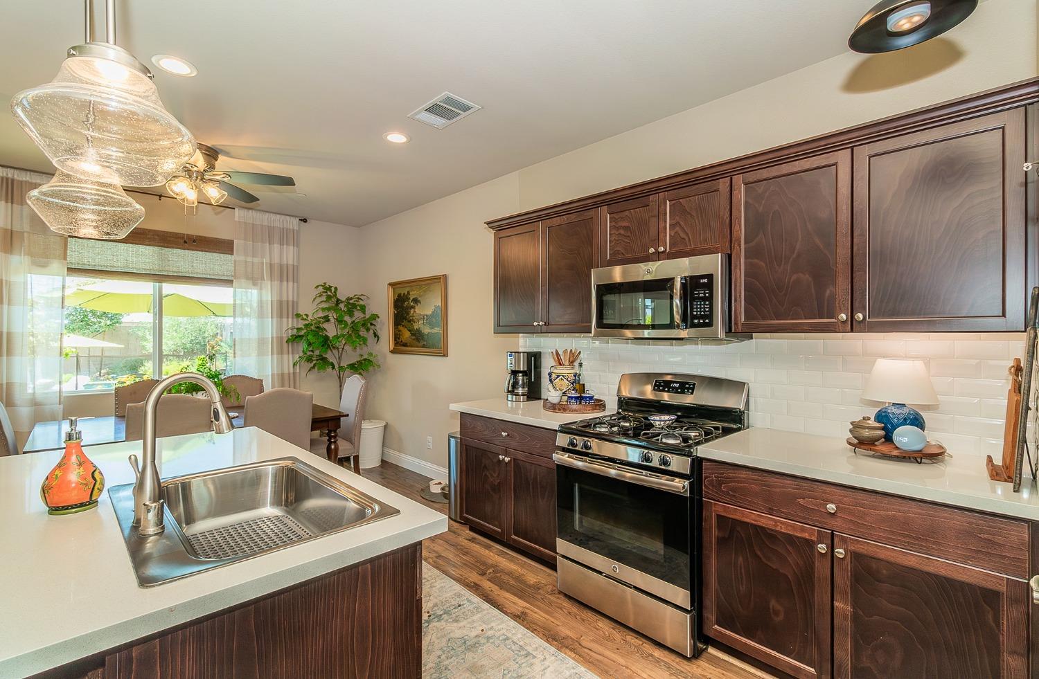 2716 Pontiac Avenue Clovis, CA 93611 - Photo 13 of 32 a kitchen with stainless steel appliances granite countertop a sink a stove and a refrigerator