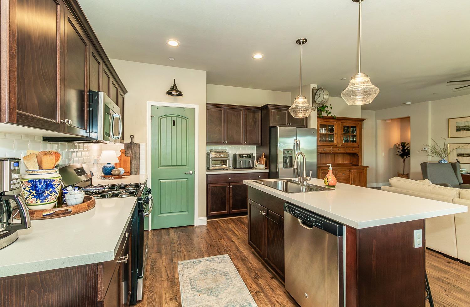 2716 Pontiac Avenue Clovis, CA 93611 - Photo 14 of 32 a kitchen with sink refrigerator and cabinets