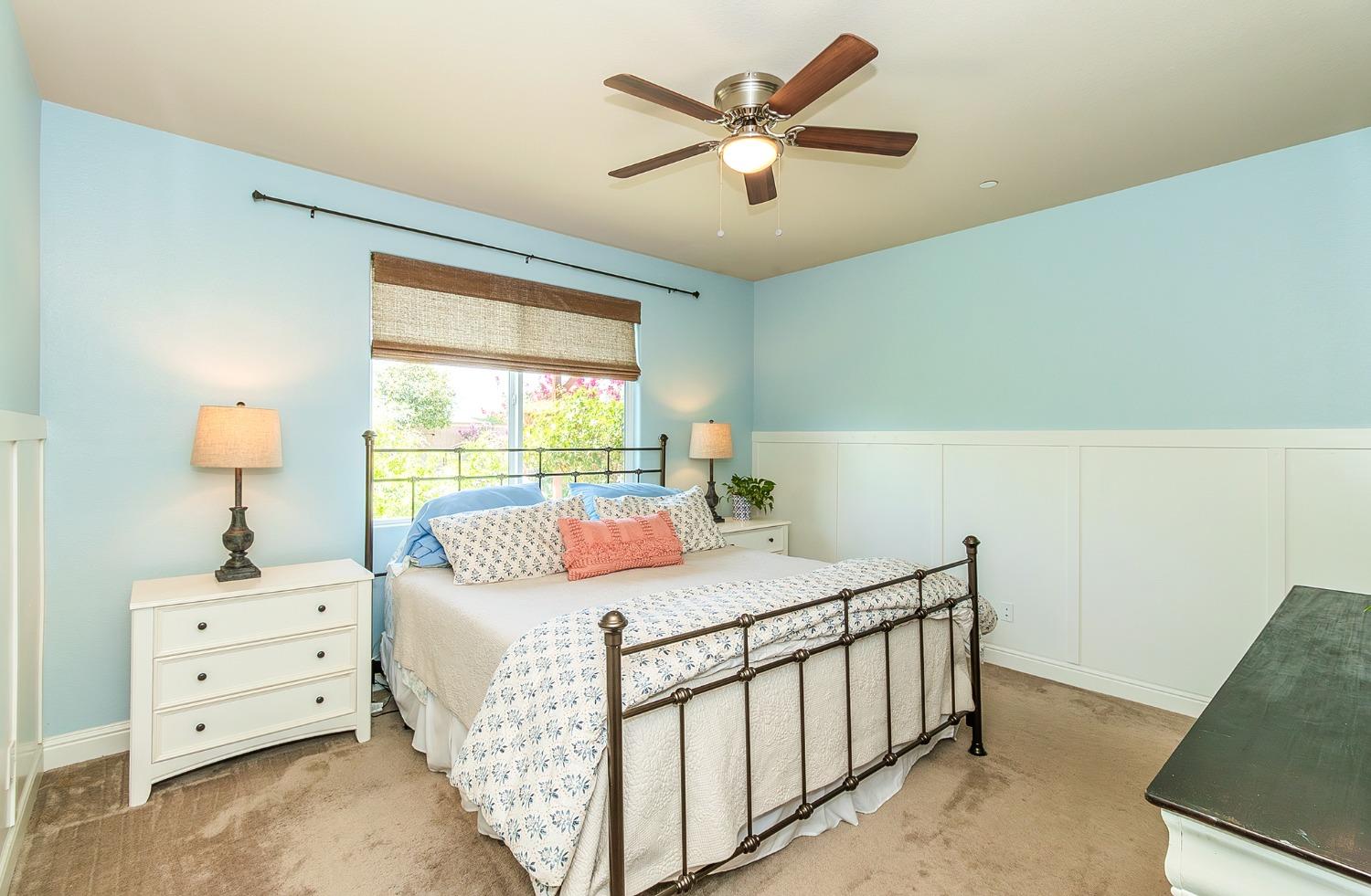 2716 Pontiac Avenue Clovis, CA 93611 - Photo 17 of 32 a bedroom with a bed and a chandelier