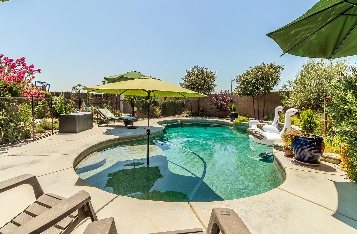 2716 Pontiac Avenue Clovis, CA 93611 - Photo 2 of 32 a view of a swimming pool and lounge chair