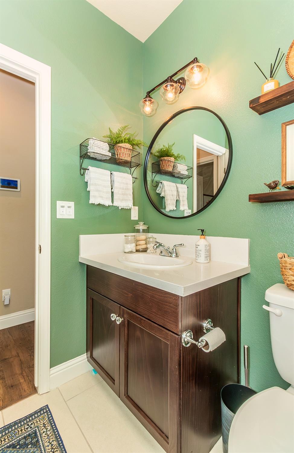 2716 Pontiac Avenue Clovis, CA 93611 - Photo 24 of 32 a bathroom with a sink mirror and toilet