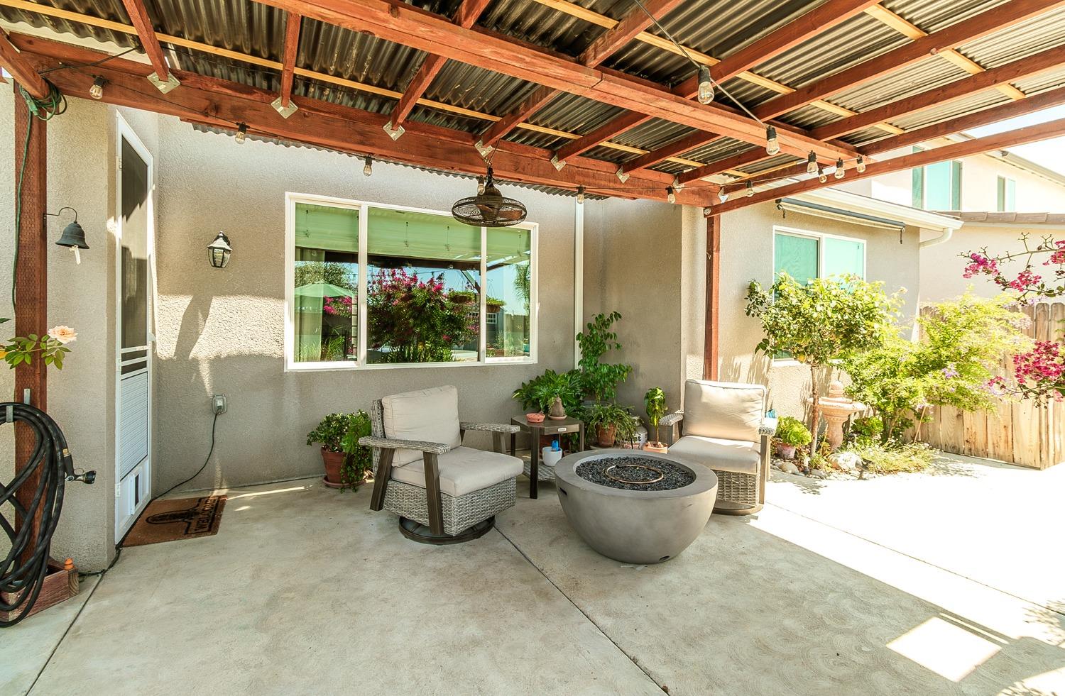 2716 Pontiac Avenue Clovis, CA 93611 - Photo 29 of 32 a view of a patio with table and chairs potted plants