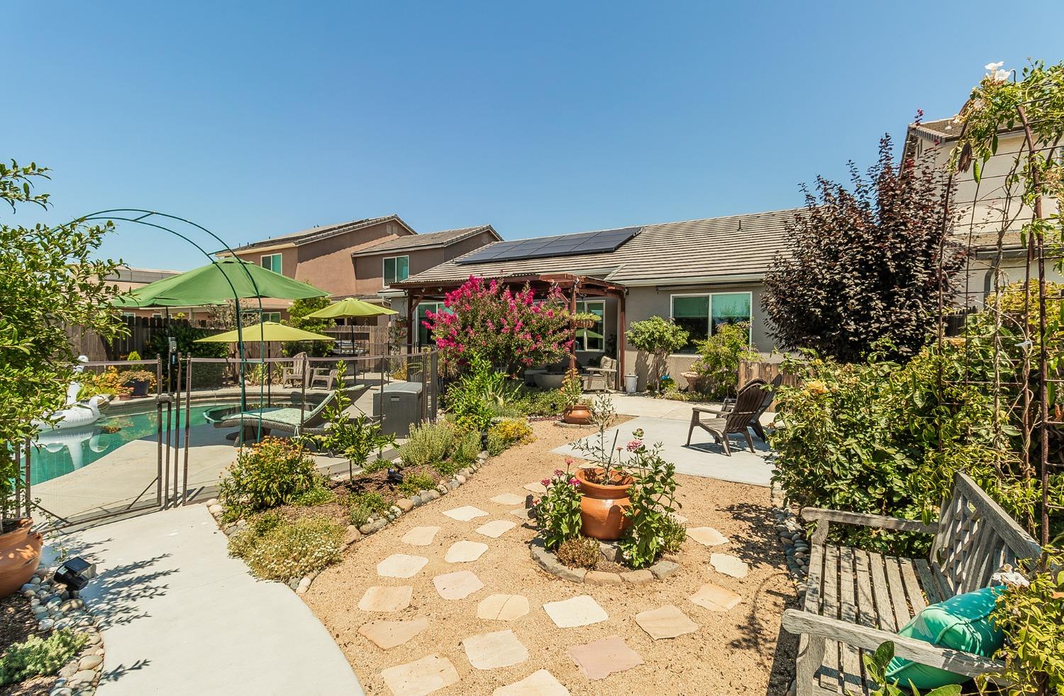 2716 Pontiac Avenue Clovis, CA 93611 - Photo 31 of 32 a view of a patio with table and chairs potted plants