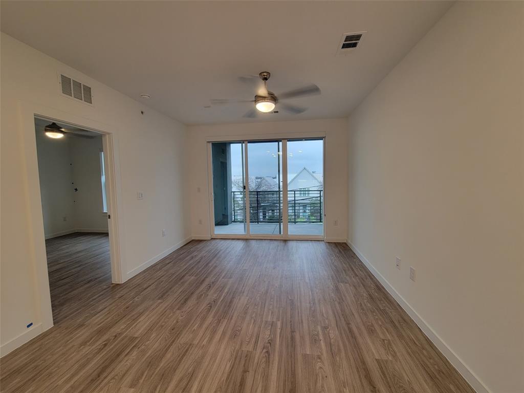 4801 Springdale Road, Unit 2211 Austin, TX 78723 - Photo 8 of 19 A living space offers direct access to a private balcony, enhancing the living experience.