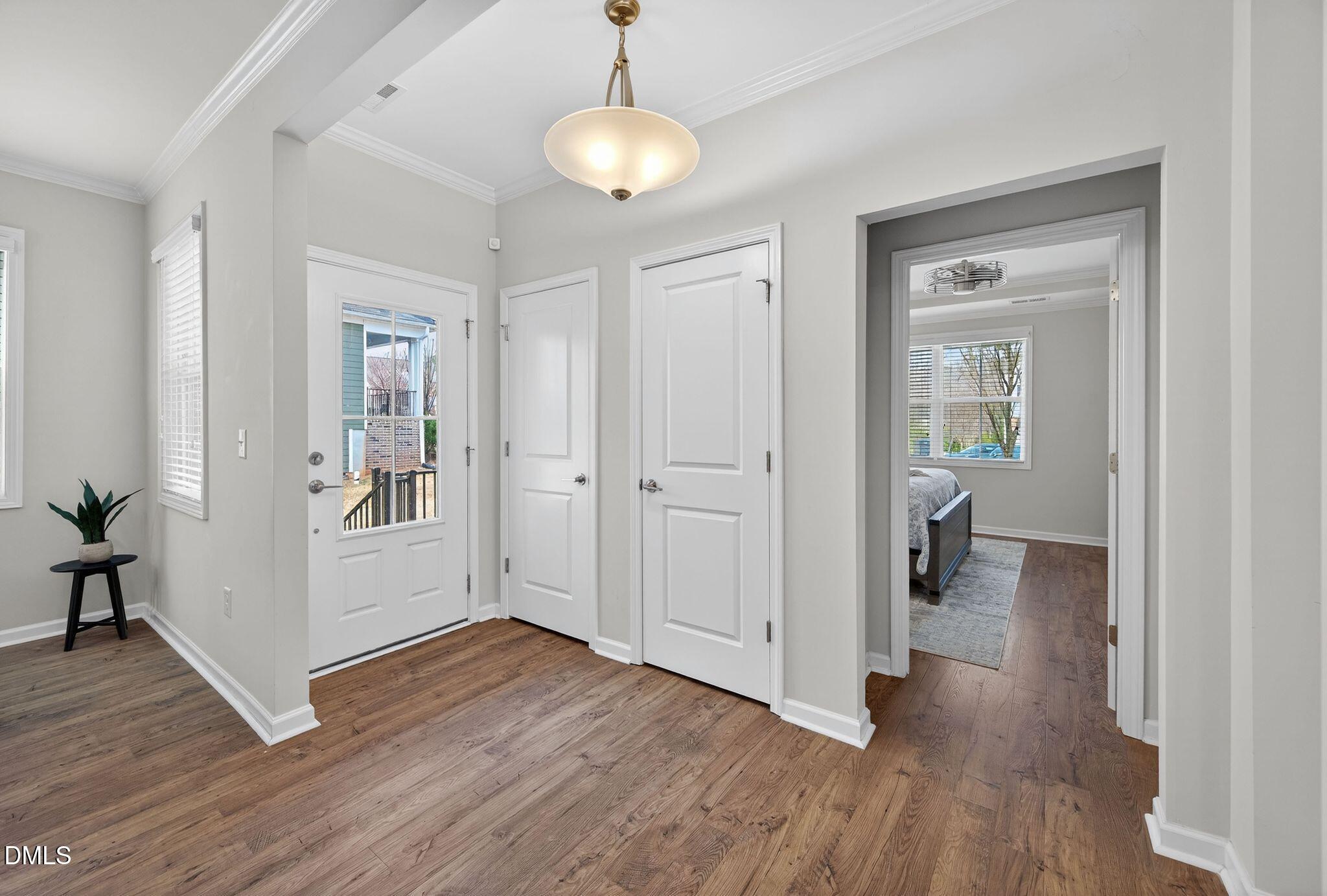 528 Spring Flower Court Cary, NC 27511 - Photo 7 of 51 a view of a hallway with wooden floor and a living room