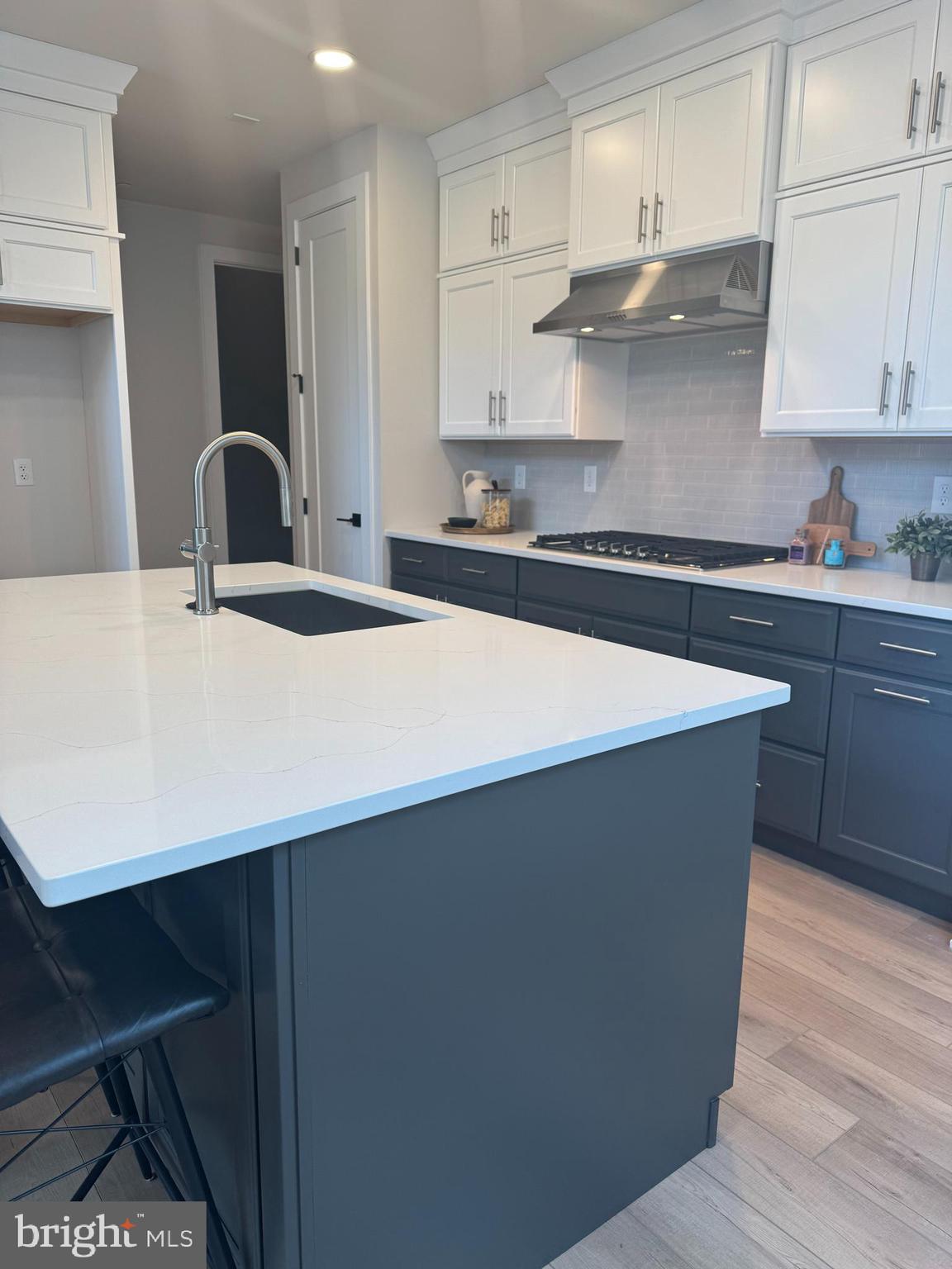 507 Trifecta Road, Unit 372 Downingtown, PA 19335 - Photo 3 of 42 a kitchen with stainless steel appliances a sink a stove a refrigerator white cabinets and wooden floor