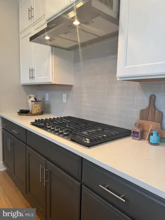 a kitchen with a cabinets and a stove top oven