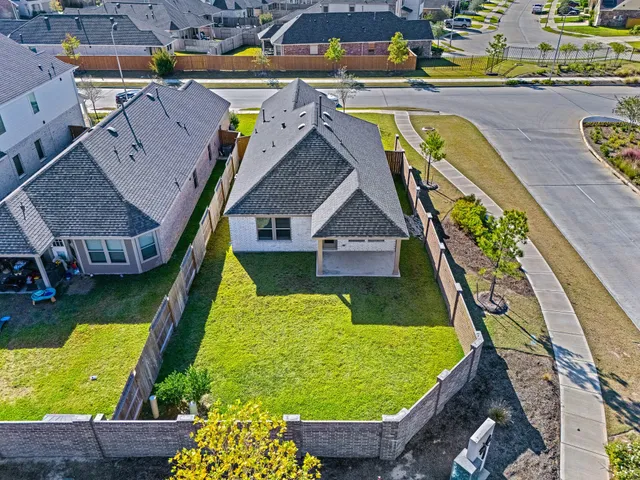 an aerial view of residential houses with outdoor space