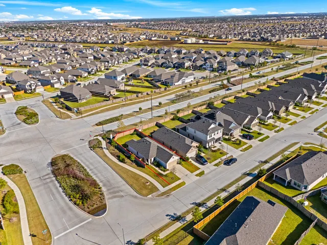 an aerial view of a residential building with parking space