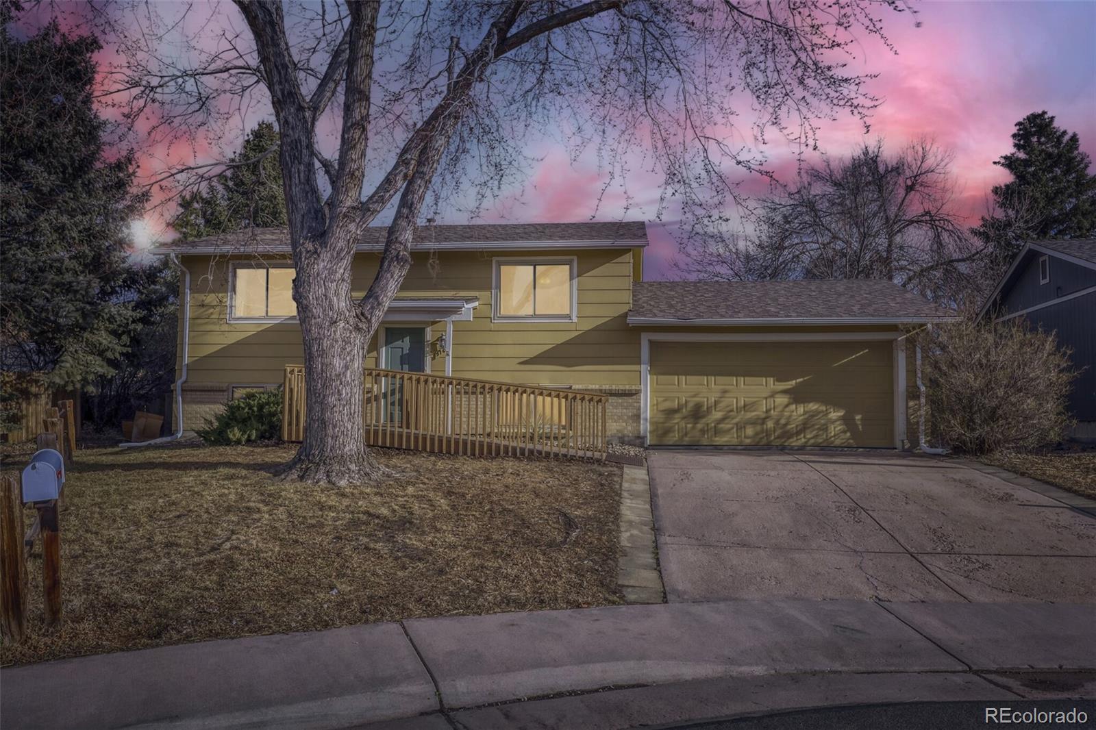 9168 Flower Court Westminster, CO 80021 - Photo 2 of 38 a front view of a house with garden