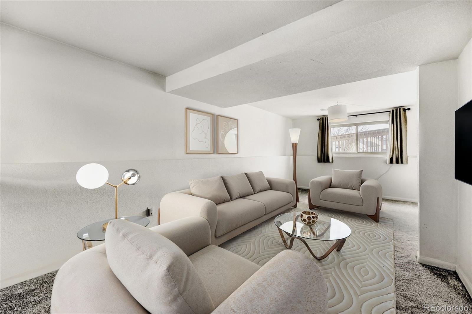 9168 Flower Court Westminster, CO 80021 - Photo 23 of 38 a living room with furniture and a couch