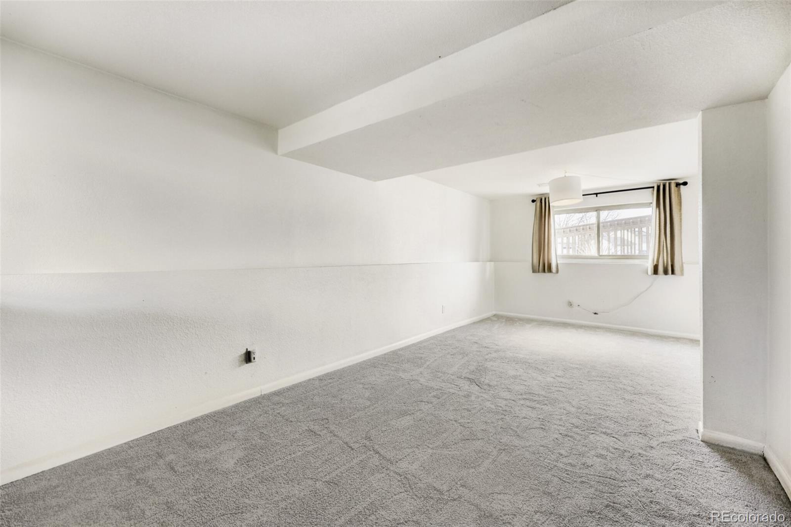 9168 Flower Court Westminster, CO 80021 - Photo 24 of 38 an empty room with a windows and cabinet