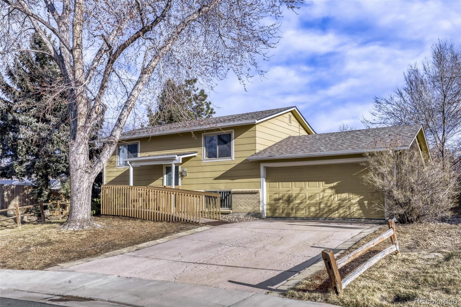 9168 Flower Court Westminster, CO 80021 - Photo 3 of 38 a view of a house with a yard and large tree