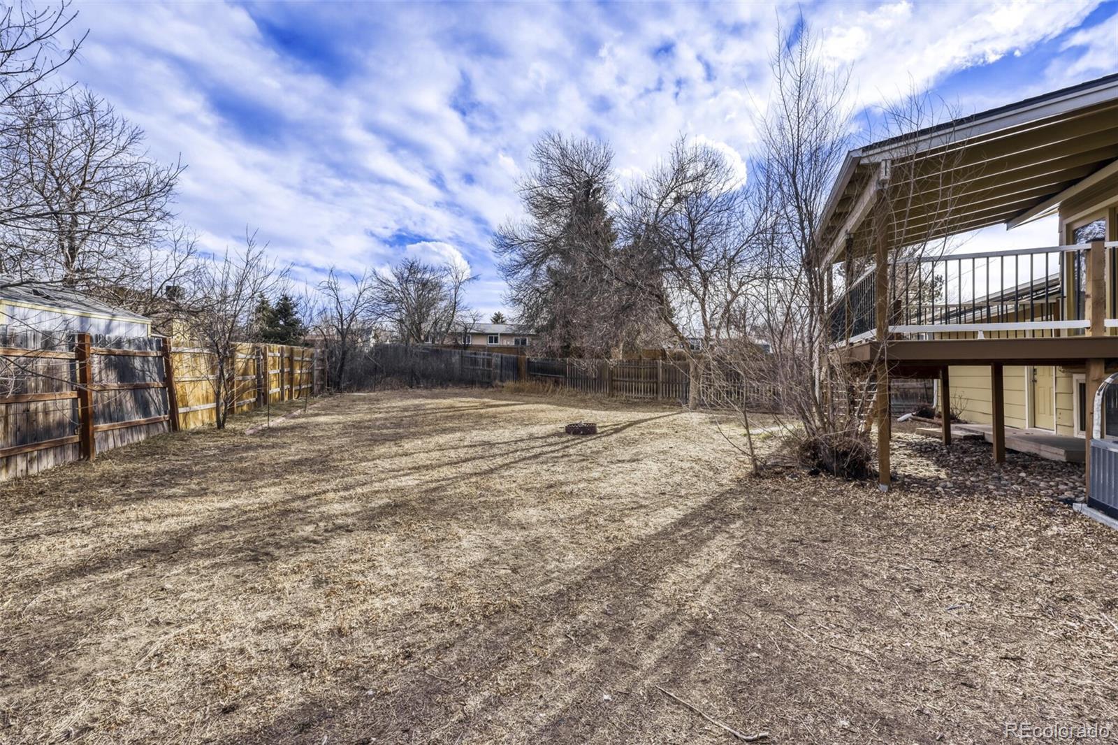 9168 Flower Court Westminster, CO 80021 - Photo 34 of 38 a view of a yard with a bench