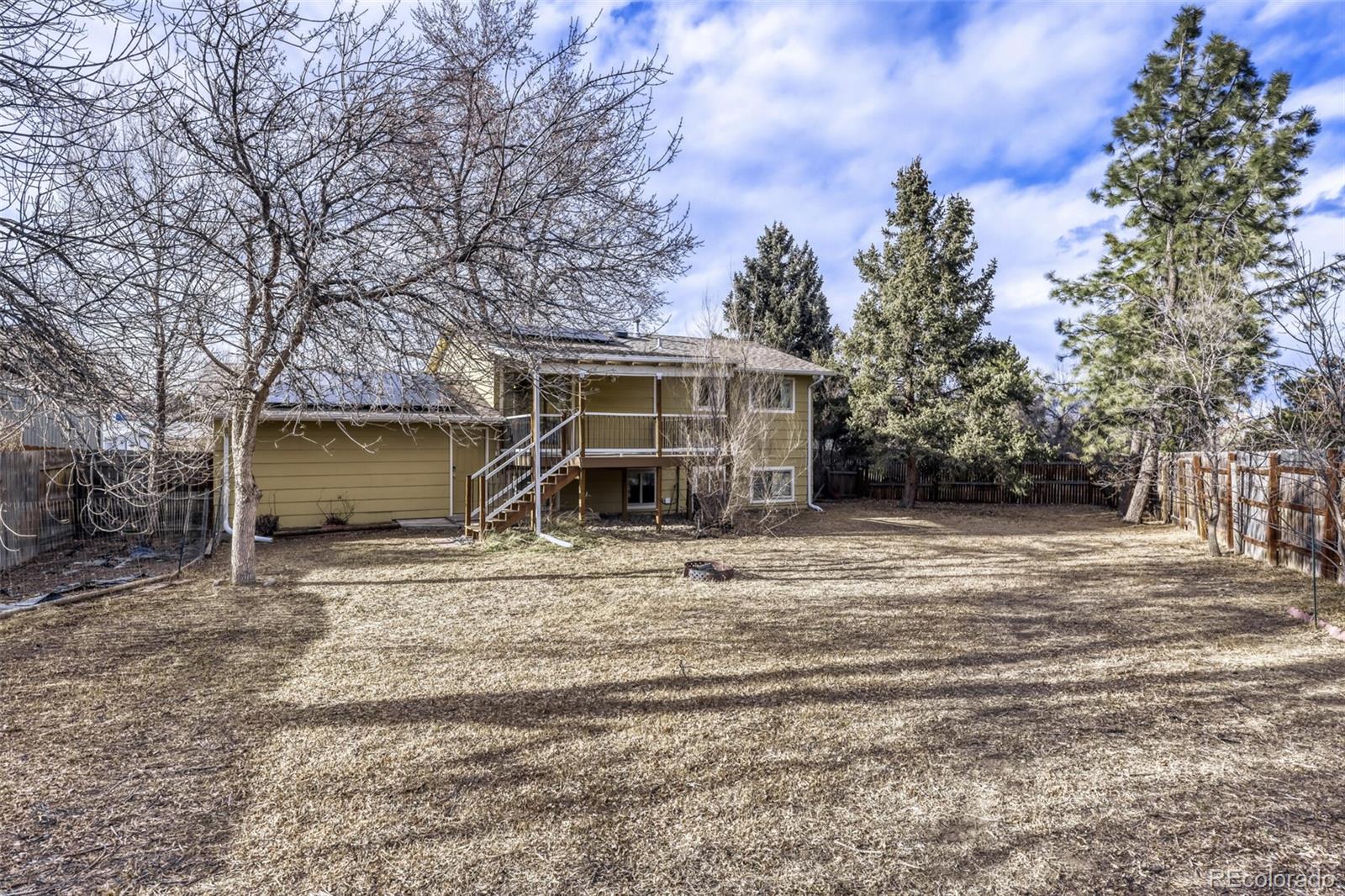 9168 Flower Court Westminster, CO 80021 - Photo 35 of 38 a view of a house with a yard and garage