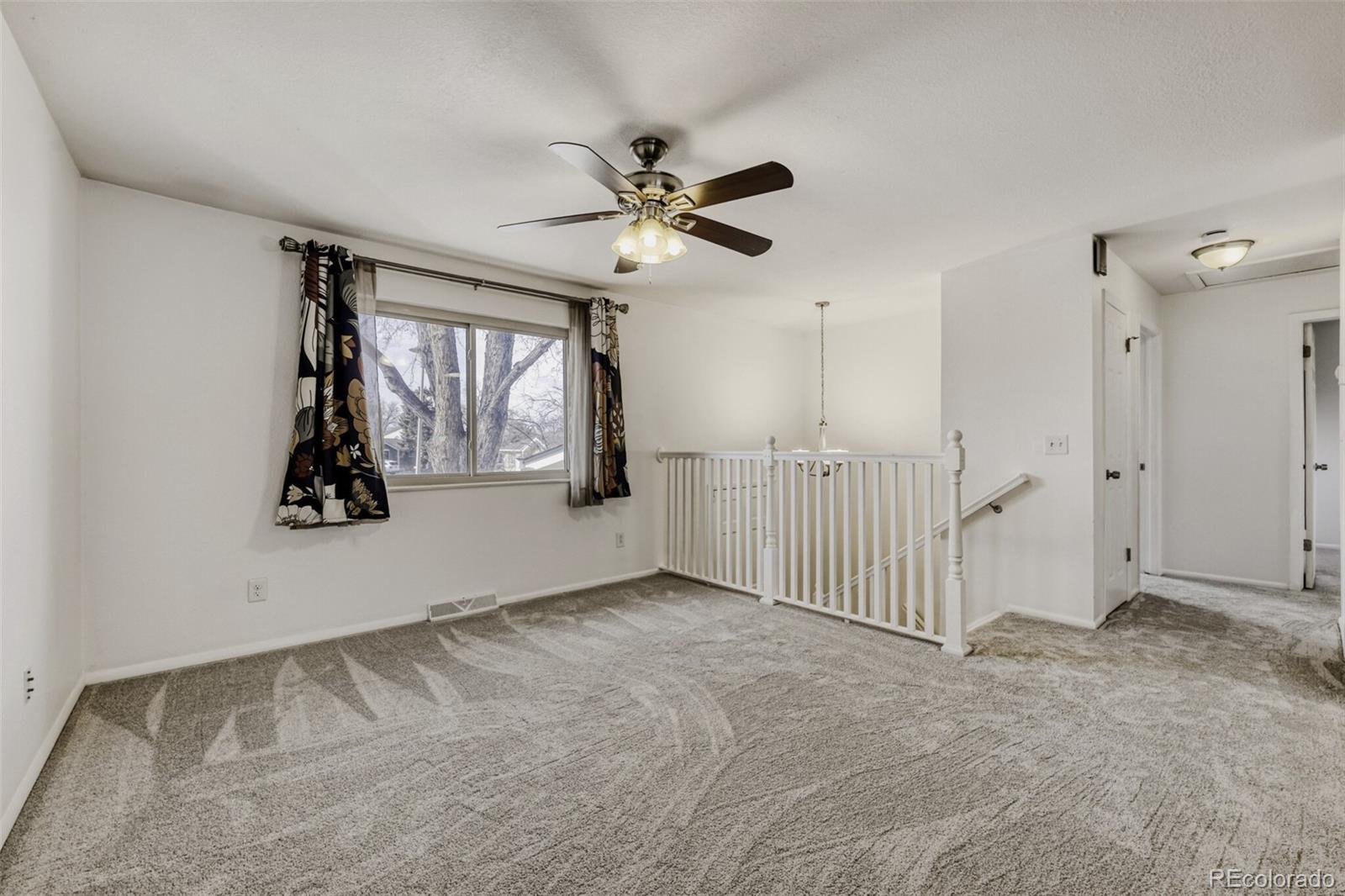 9168 Flower Court Westminster, CO 80021 - Photo 7 of 38 wooden floor in an empty room