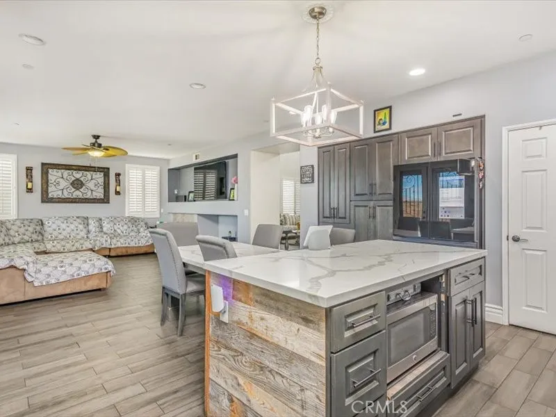 15851 Sulphur Springs Road Moreno Valley, CA 92555 - Photo 17 of 47 a view of a dining room with furniture wooden floor and chandelier