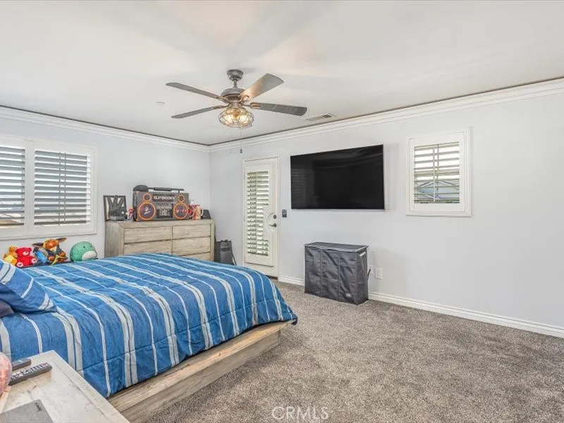 15851 Sulphur Springs Road Moreno Valley, CA 92555 - Photo 28 of 47 a bedroom with a bed and a flat screen tv