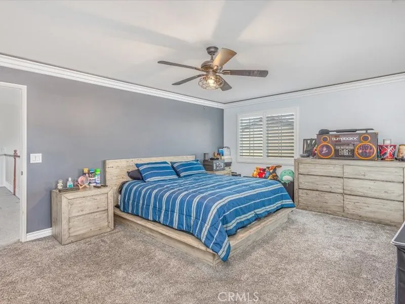 15851 Sulphur Springs Road Moreno Valley, CA 92555 - Photo 29 of 47 a bedroom with a bed and a chandelier