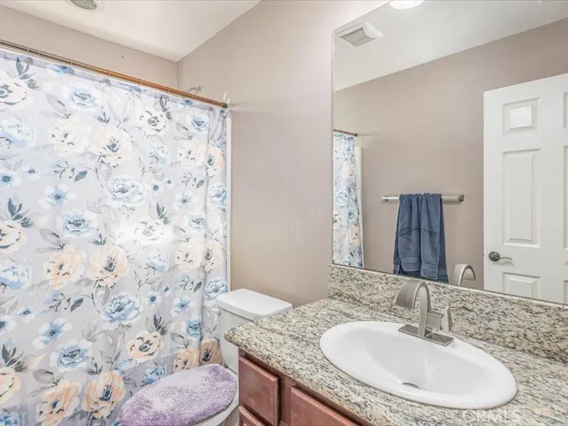 15851 Sulphur Springs Road Moreno Valley, CA 92555 - Photo 33 of 47 a bathroom with a sink toilet and shower