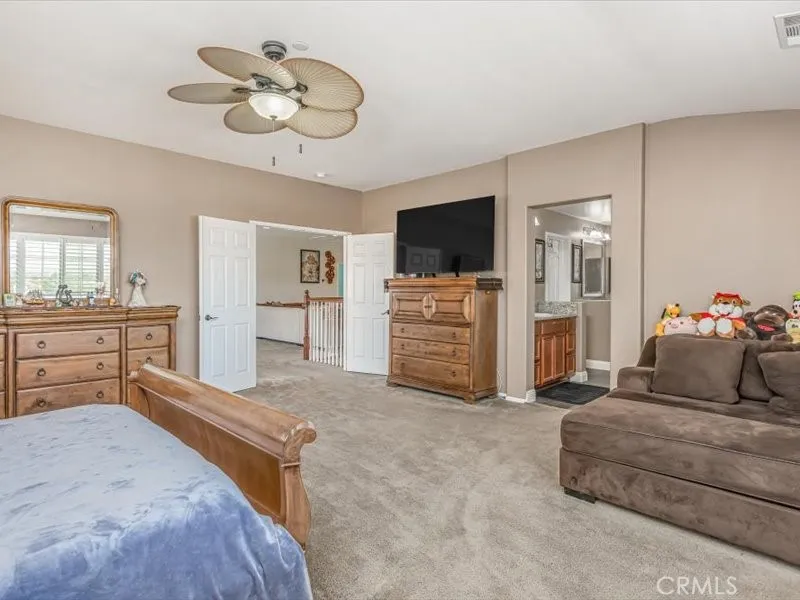 15851 Sulphur Springs Road Moreno Valley, CA 92555 - Photo 38 of 47 a bedroom with furniture and a flat screen tv