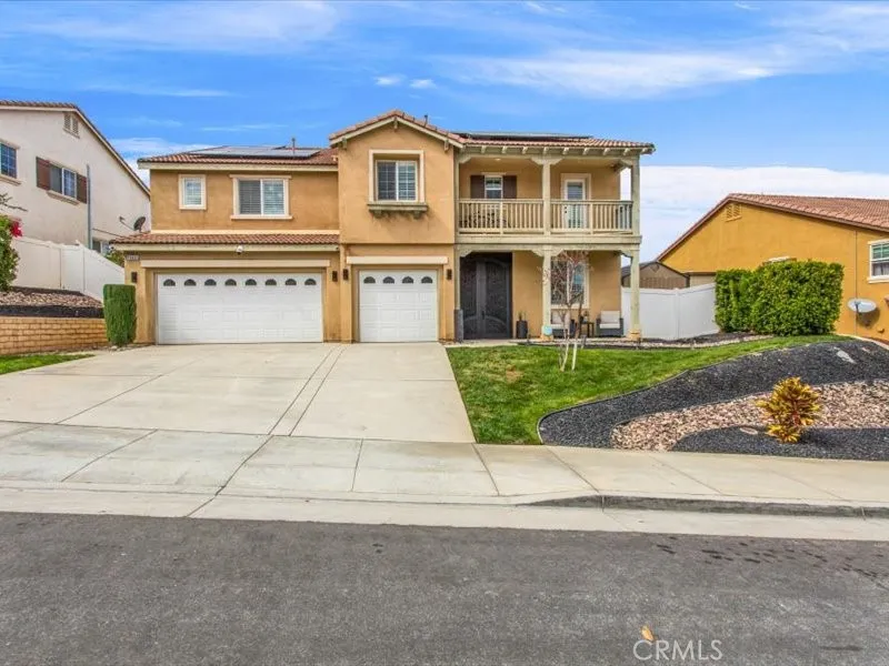 15851 Sulphur Springs Road Moreno Valley, CA 92555 - Photo 4 of 47 a front view of a house with a yard and garage