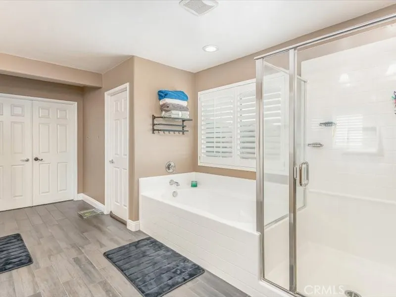 15851 Sulphur Springs Road Moreno Valley, CA 92555 - Photo 41 of 47 a bathroom with a bathtub a shower a sink and a window