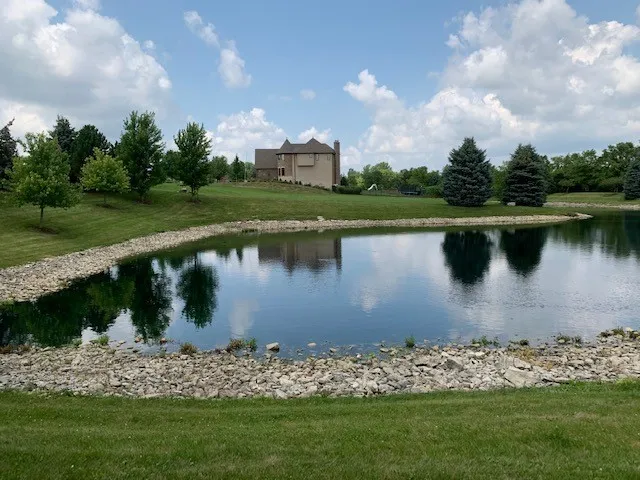 a view of a lake with a house in the background