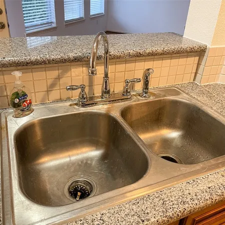 a view of a water fountain and a dining table next to a window