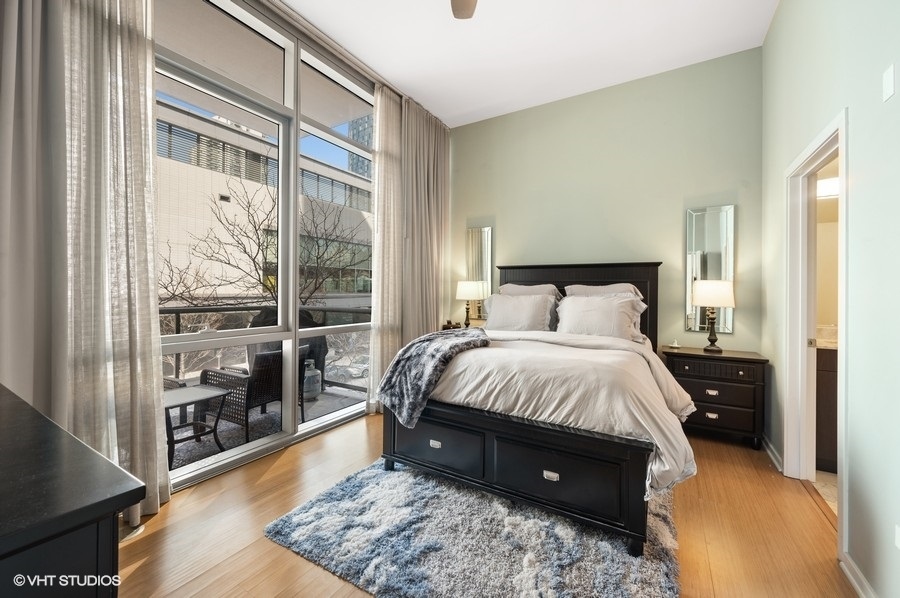 123 South Green Street, Unit 201B Chicago, IL 60607 - Photo 11 of 19 a spacious bedroom with a bed and a large window