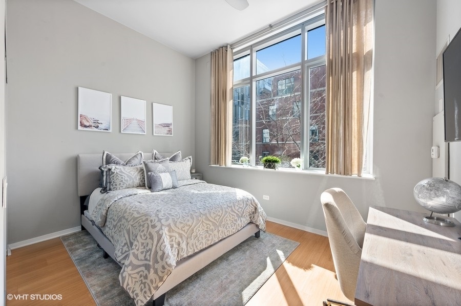 123 South Green Street, Unit 201B Chicago, IL 60607 - Photo 13 of 19 a bedroom with a bed and a large window