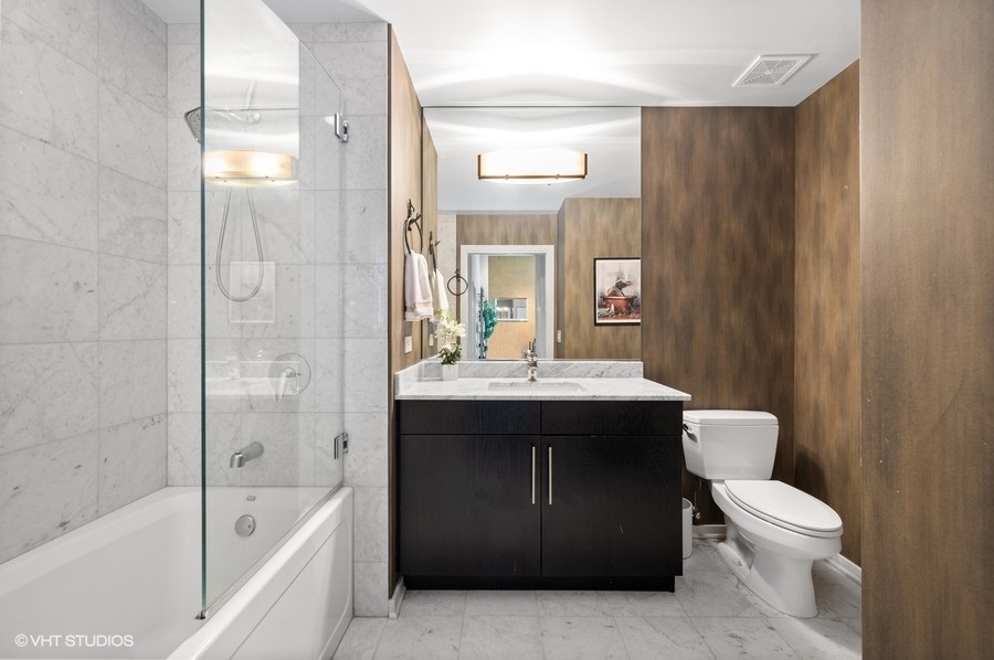 123 South Green Street, Unit 201B Chicago, IL 60607 - Photo 14 of 19 a bathroom with a sink a toilet and shower