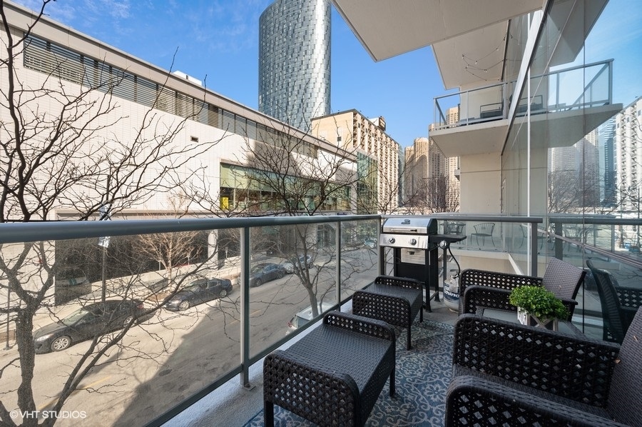 123 South Green Street, Unit 201B Chicago, IL 60607 - Photo 16 of 19 a view of balcony with chairs and potted plant