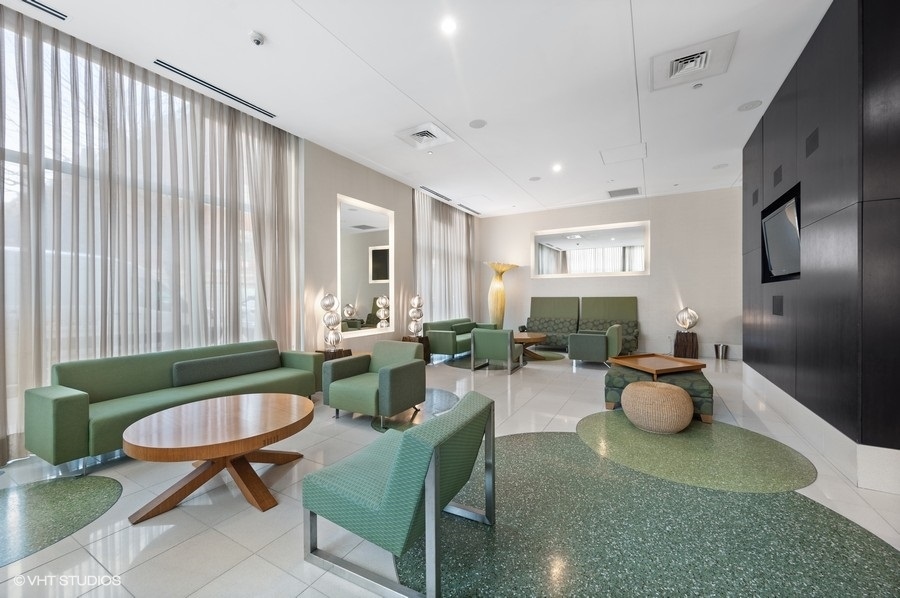 123 South Green Street, Unit 201B Chicago, IL 60607 - Photo 17 of 19 a living room with furniture and a potted plant