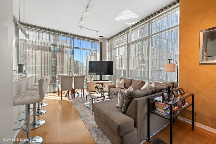123 South Green Street, Unit 201B Chicago, IL 60607 - Photo 6 of 19 a living room with furniture and a flat screen tv