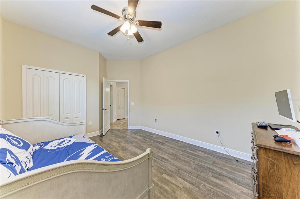 12642 Harney Street Venice, FL 34293 - Photo 39 of 85 a living room with furniture and a ceiling fan