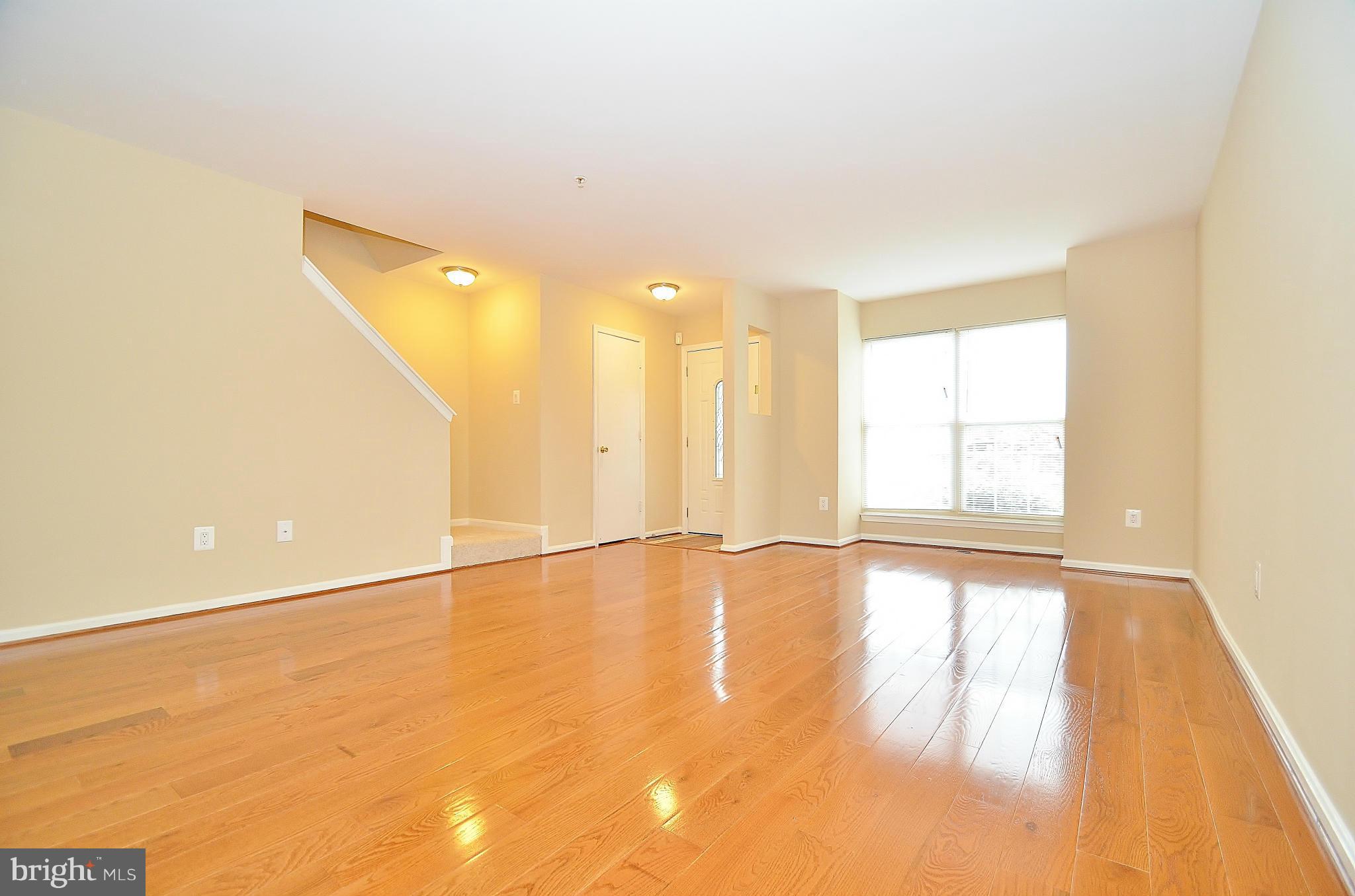 1331 Hazel Street Baltimore, MD 21226 - Photo 2 of 19 a view of an empty room with wooden floor and a window