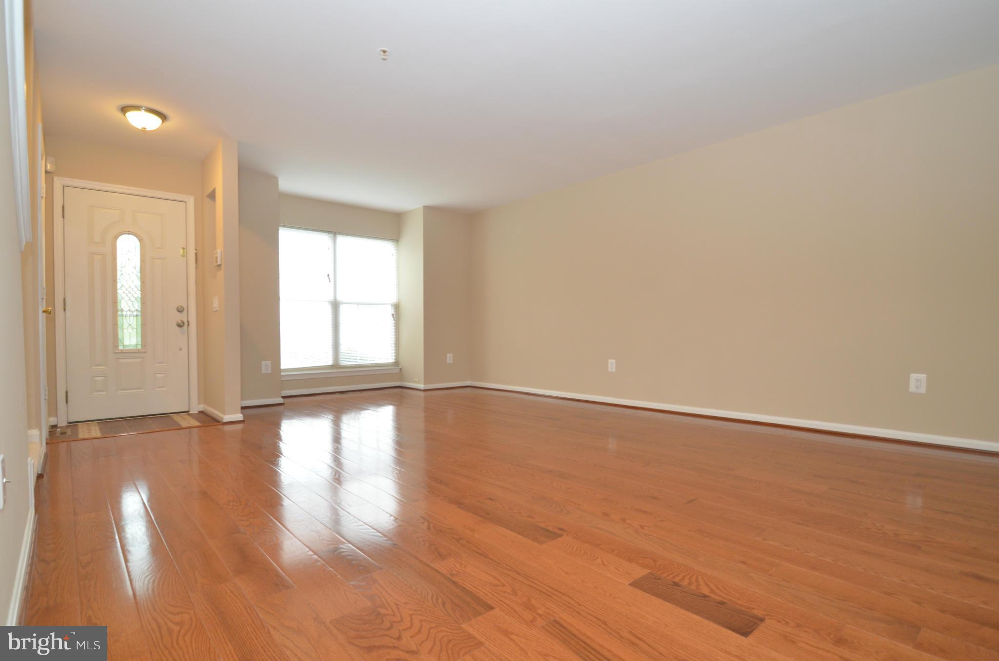 1331 Hazel Street Baltimore, MD 21226 - Photo 5 of 19 a view of an empty room with wooden floor and a window