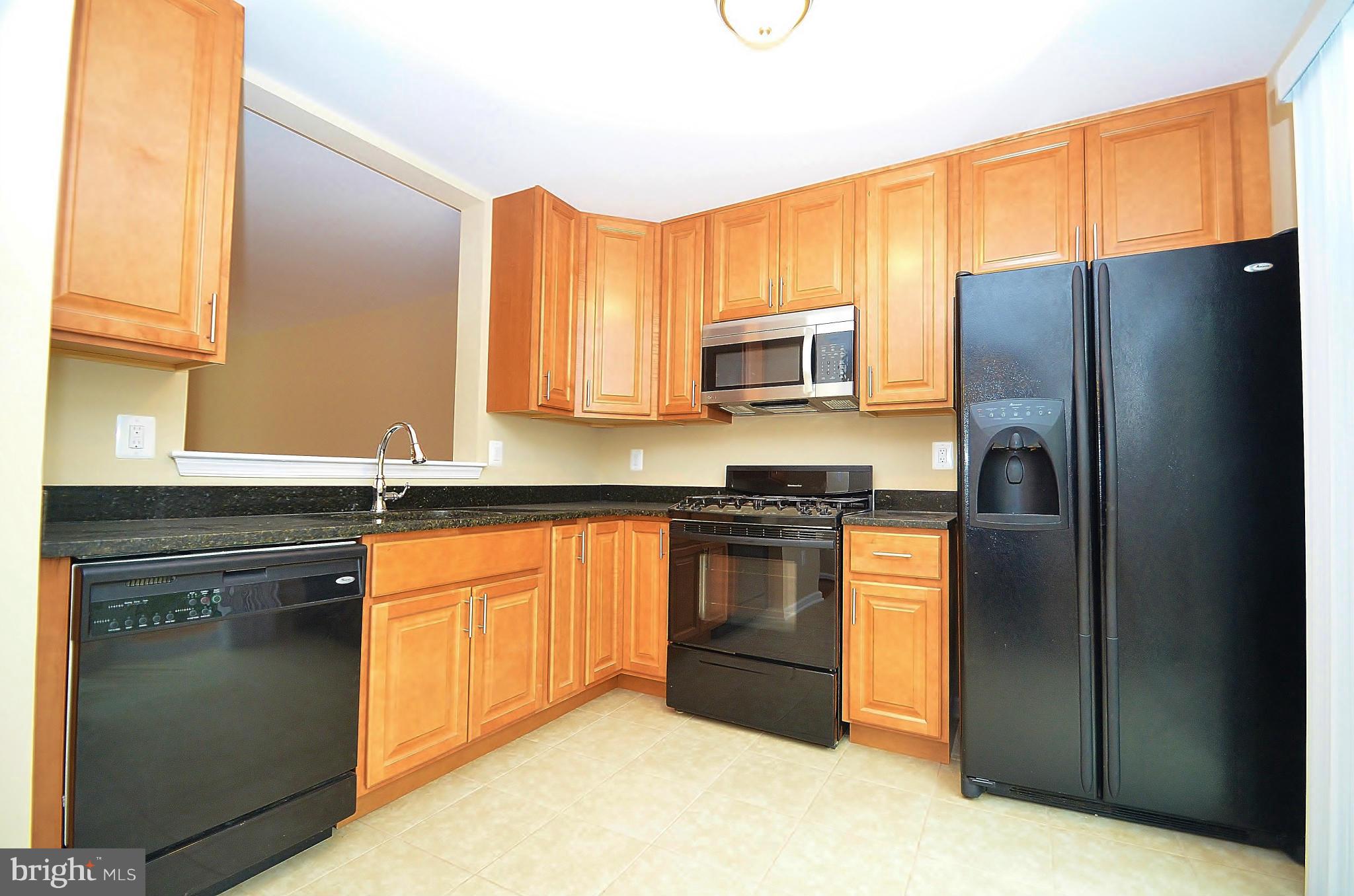 1331 Hazel Street Baltimore, MD 21226 - Photo 6 of 19 a kitchen with stainless steel appliances granite countertop a refrigerator stove and microwave