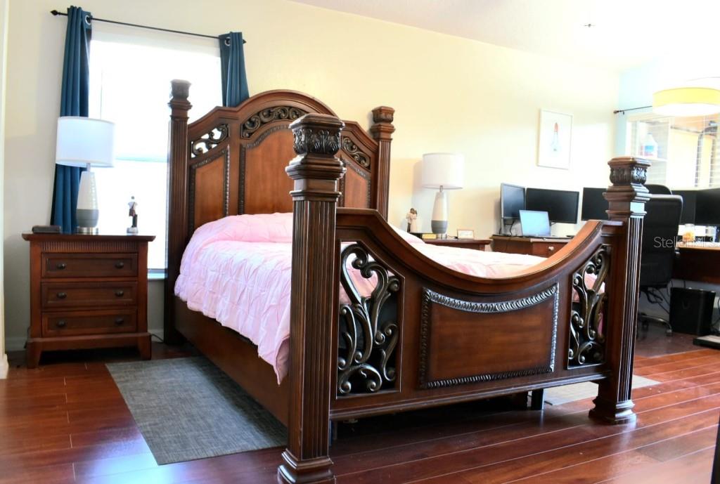 13541 Tetherline Trail Orlando, FL 32837 - Photo 16 of 39 a bed room with a bed and a dresser