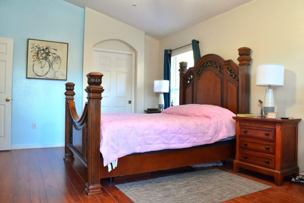 13541 Tetherline Trail Orlando, FL 32837 - Photo 17 of 39 a bed room with a bed and a night stand