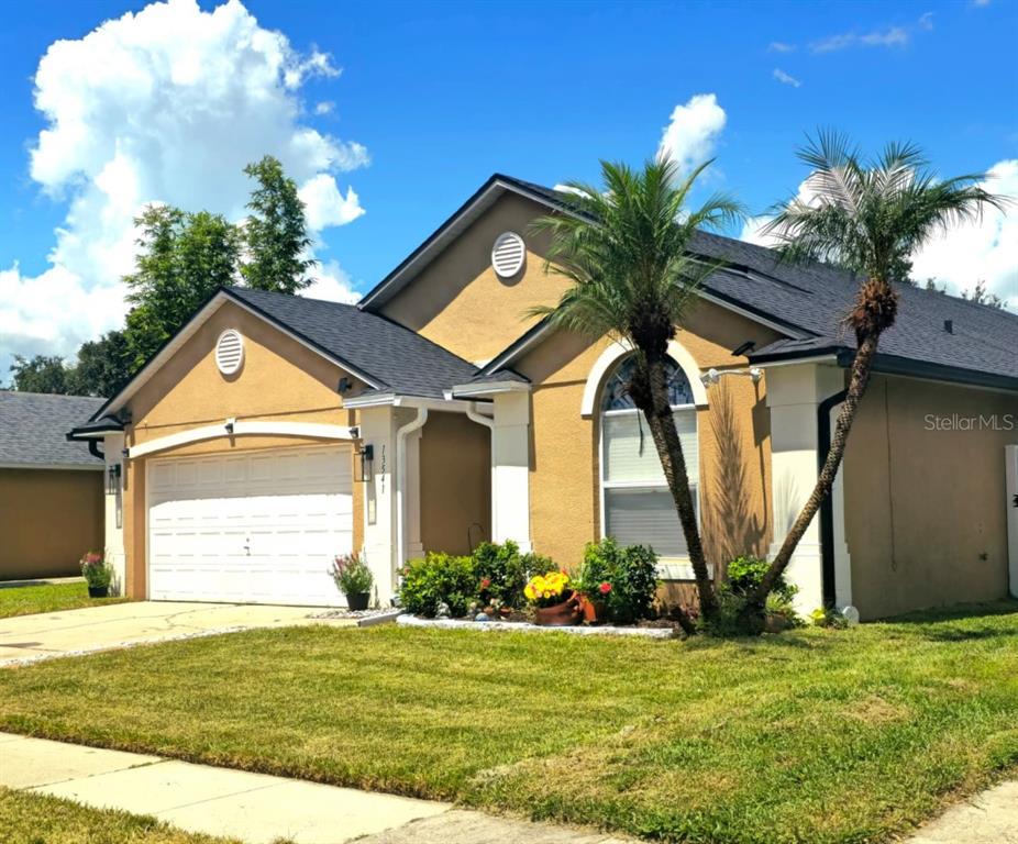 13541 Tetherline Trail Orlando, FL 32837 - Photo 2 of 39 a view of a house with a large windows and a yard