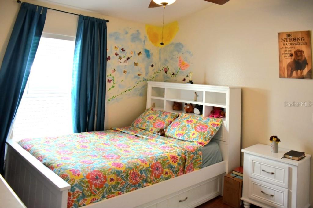 13541 Tetherline Trail Orlando, FL 32837 - Photo 23 of 39 a bedroom with a bed and window