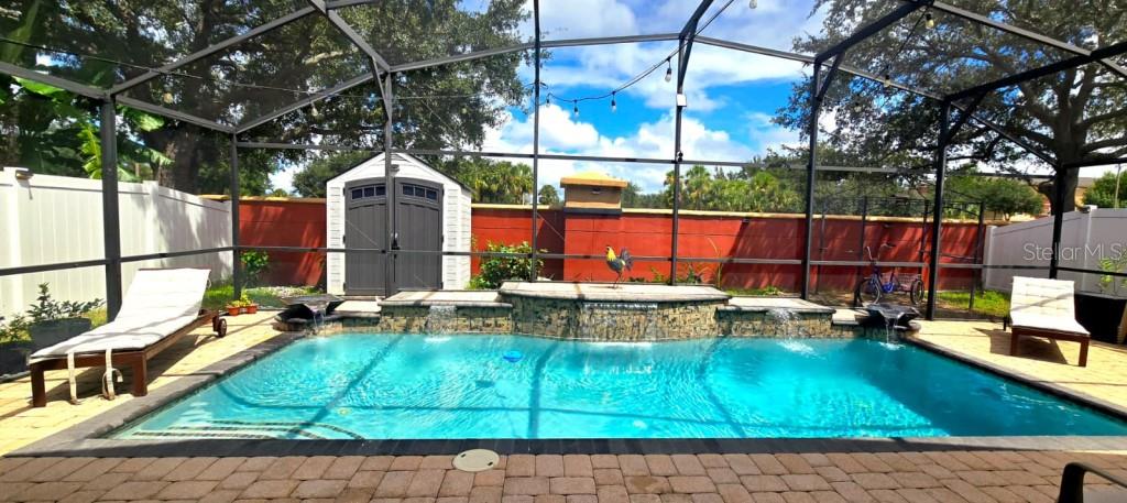 13541 Tetherline Trail Orlando, FL 32837 - Photo 4 of 39 a view of a swimming pool with a patio
