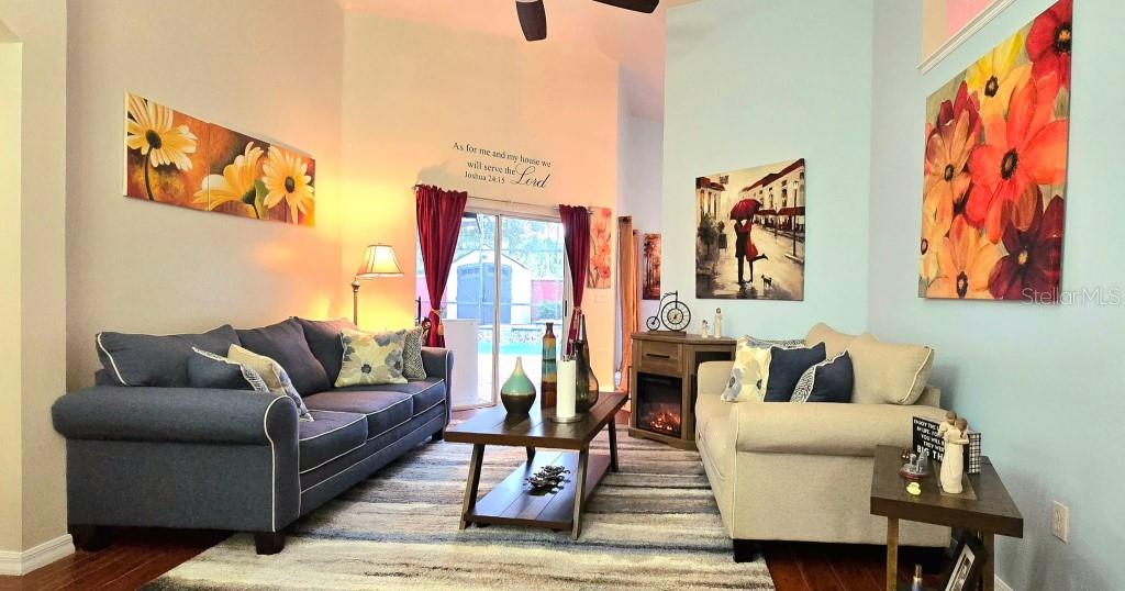 13541 Tetherline Trail Orlando, FL 32837 - Photo 7 of 39 a living room with furniture and a painting on the wall